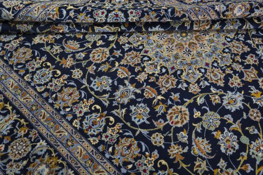Corner detail of 2000s Kashan rug showing border pattern and Wool pile