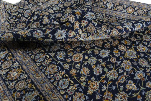 Close-up detail of 2000s Kashan rug from Iran / Persia showing Wool weave