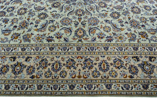 Corner detail of 2000s Kashan rug showing border pattern and Wool pile