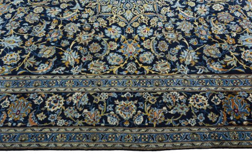 Corner detail of 2000s Kashan rug showing border pattern and Wool pile