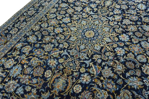 Backside of handmade 2000s Kashan rug showing knot structure and weave density
