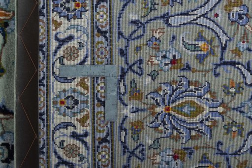 Backside of handmade 2000s Kashan rug showing knot structure and weave density
