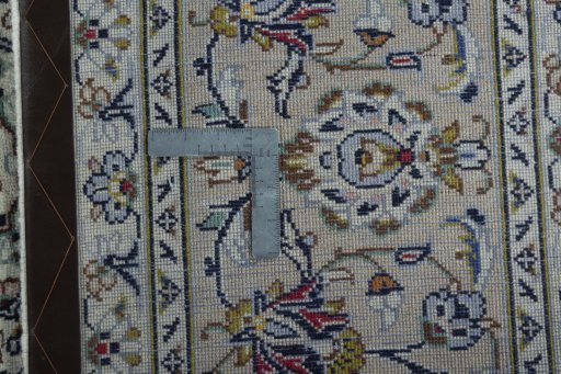 Backside of handmade 2000s Kashan rug showing knot structure and weave density