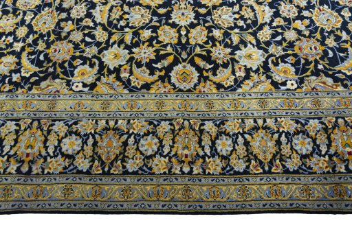 Corner detail of 2000s Kashan rug showing border pattern and Wool pile
