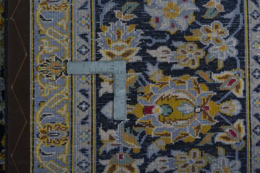 Backside of handmade 2000s Kashan rug showing knot structure and weave density