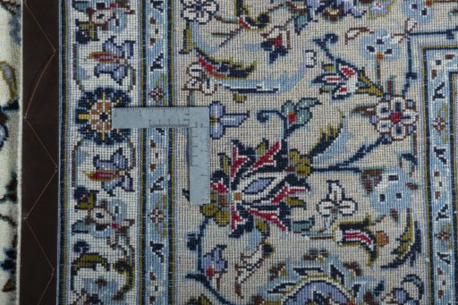 Backside of handmade 2000s Kashan rug showing knot structure and weave density