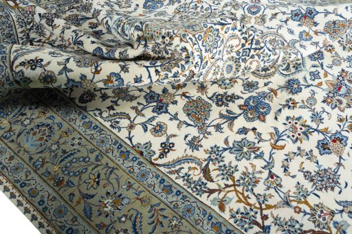 Backside of handmade 2000s Kashan rug showing knot structure and weave density