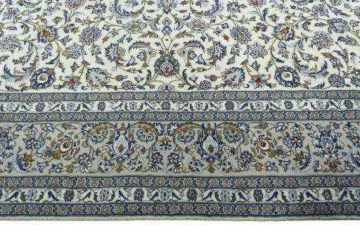 Corner detail of 2000s Kashan rug showing border pattern and Wool pile