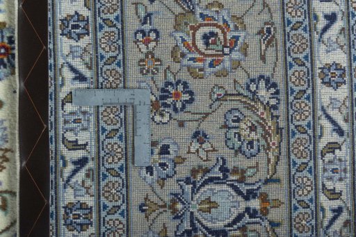 Backside of handmade 2000s Kashan rug showing knot structure and weave density