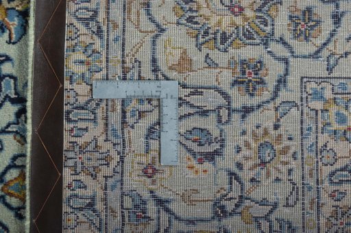 Backside of handmade 2000s Kashan rug showing knot structure and weave density
