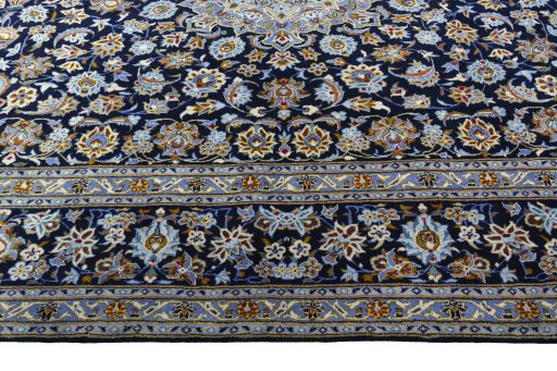 Corner detail of 2000s Kashan rug showing border pattern and Wool pile