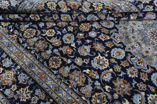 Close-up detail of 2000s Kashan rug from Iran / Persia showing Wool weave