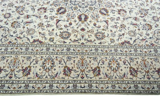 Corner detail of 2000s Kashan rug showing border pattern and Wool pile