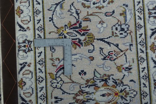 Backside of handmade 2000s Kashan rug showing knot structure and weave density