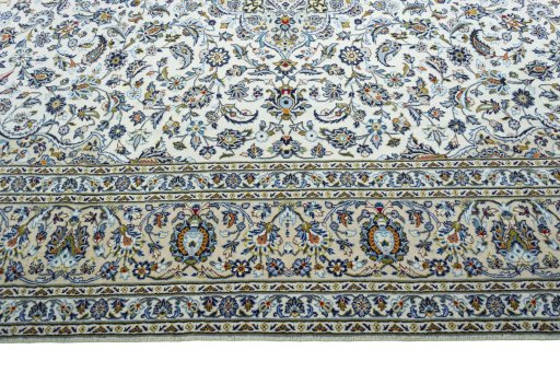 Corner detail of 2000s Kashan rug showing border pattern and Wool pile