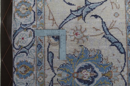 Backside of handmade 2000s Kashan rug showing knot structure and weave density