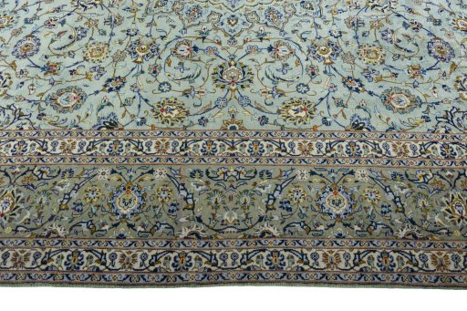 Corner detail of 2000s Kashan rug showing border pattern and Wool pile