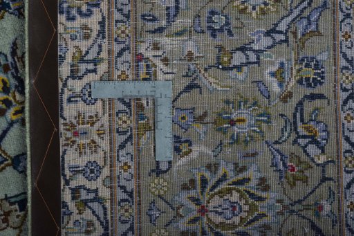 Backside of handmade 2000s Kashan rug showing knot structure and weave density
