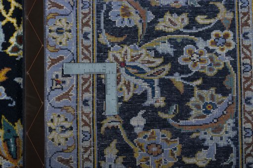 Backside of handmade New Kashan rug showing knot structure and weave density