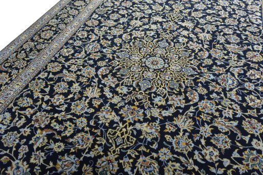 Backside of handmade New Kashan rug showing knot structure and weave density