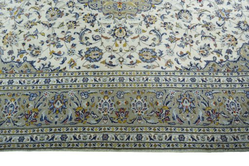 Corner detail of 2000s Kashan rug showing border pattern and Wool pile