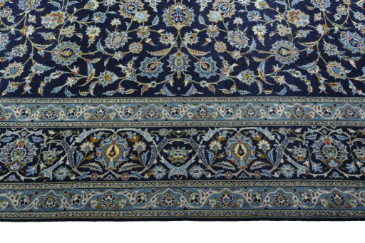 Corner detail of 2000s Kashan rug showing border pattern and Wool pile
