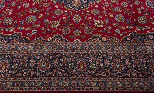 Corner detail of 2000s Kashan rug showing border pattern and Wool pile