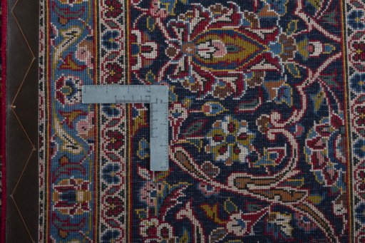 Backside of handmade 2000s Kashan rug showing knot structure and weave density