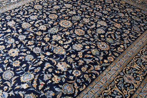 Corner detail of 2000s Kashan rug showing border pattern and Wool pile