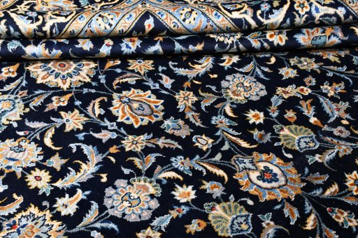 Corner detail of 2000s Kashan rug showing border pattern and Wool pile