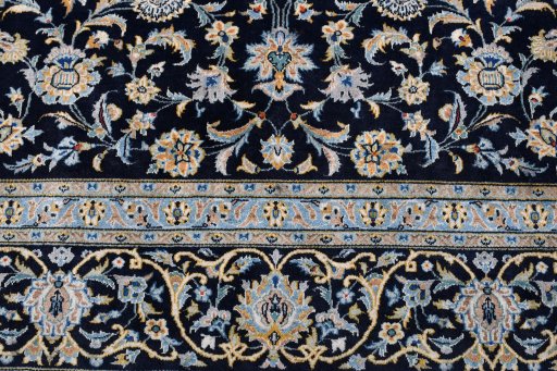 Backside of handmade 2000s Kashan rug showing knot structure and weave density