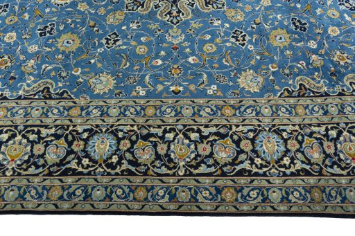 Corner detail of 2000s Kashan rug showing border pattern and Wool pile
