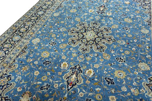 Backside of handmade 2000s Kashan rug showing knot structure and weave density
