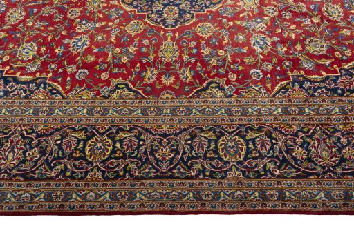 Corner detail of 2000s Kashan rug showing border pattern and Wool pile