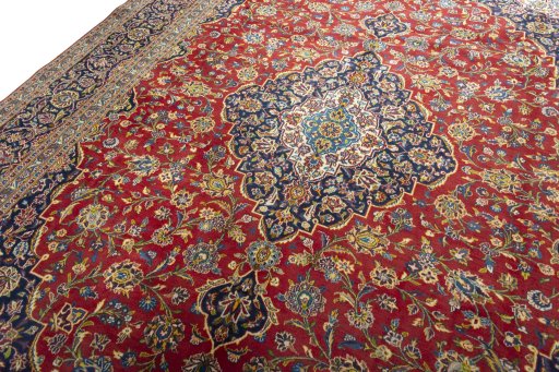 Backside of handmade 2000s Kashan rug showing knot structure and weave density