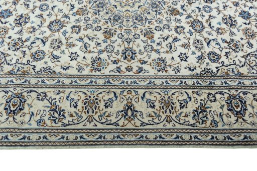 Corner detail of 2000s Kashan rug showing border pattern and Wool pile