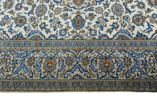 Corner detail of 2000s Kashan rug showing border pattern and Wool pile