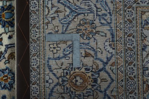 Backside of handmade 2000s Kashan rug showing knot structure and weave density