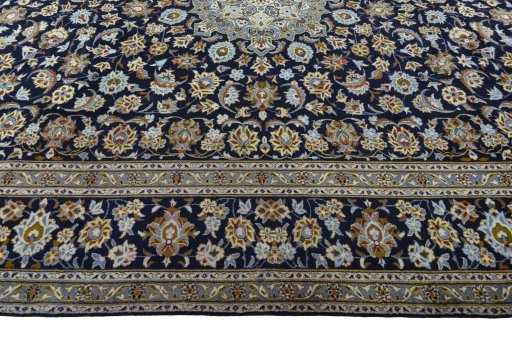 Corner detail of 2000s Kashan rug showing border pattern and Wool pile