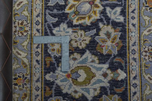 Backside of handmade 2000s Kashan rug showing knot structure and weave density