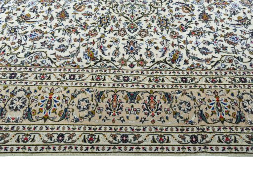 Corner detail of 2000s Kashan rug showing border pattern and Wool pile