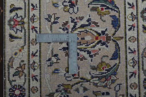 Backside of handmade 2000s Kashan rug showing knot structure and weave density