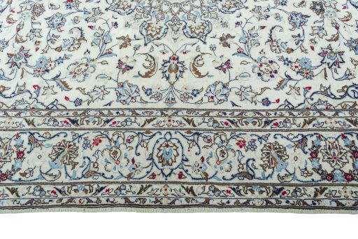Corner detail of 2000s Kashan rug showing border pattern and Wool pile