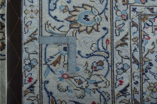 Backside of handmade 2000s Kashan rug showing knot structure and weave density