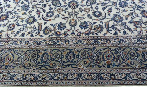 Corner detail of 2000s Kashan rug showing border pattern and Wool pile
