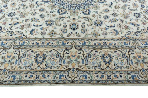 Corner detail of 2000s Kashan rug showing border pattern and Wool pile