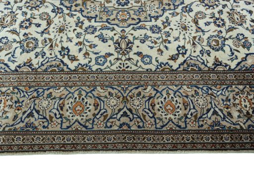 Corner detail of 2000s Kashan rug showing border pattern and Wool pile