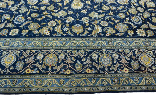 Corner detail of 2000s Kashan rug showing border pattern and Wool pile