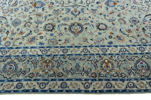 Corner detail of 2000s Kashan rug showing border pattern and Wool pile