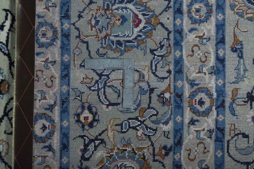 Backside of handmade 2000s Kashan rug showing knot structure and weave density